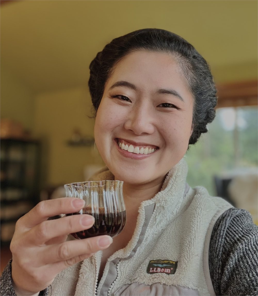 Vevien smiling with tea and cultural objects